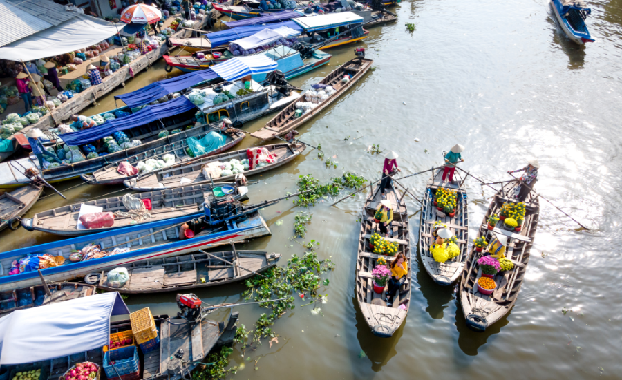 A typical scene at Thailand’s floating markets, with colorful boats carrying fresh produce and local goods