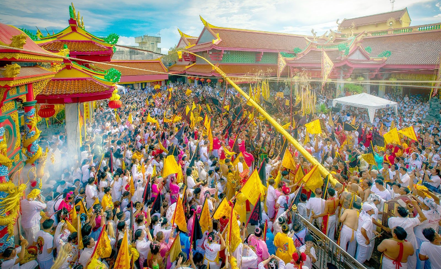 People in white taking part in the Phuket Vegetarian Festival ceremony