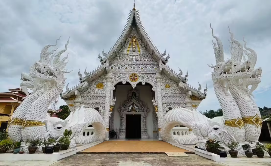 The temple’s entrance is adorned with intricately carved Naga serpents, a distinctive feature of Lanna-style Buddhist architecture