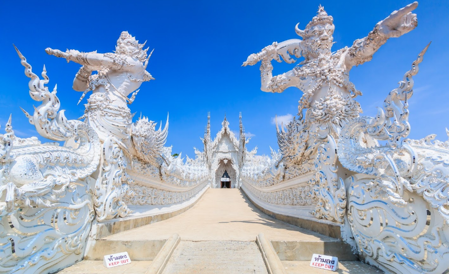 Two giant figures Rahu and Death of Wat Rong Khun, symbolizing fate and the impermanence of life at the Gate of Heaven