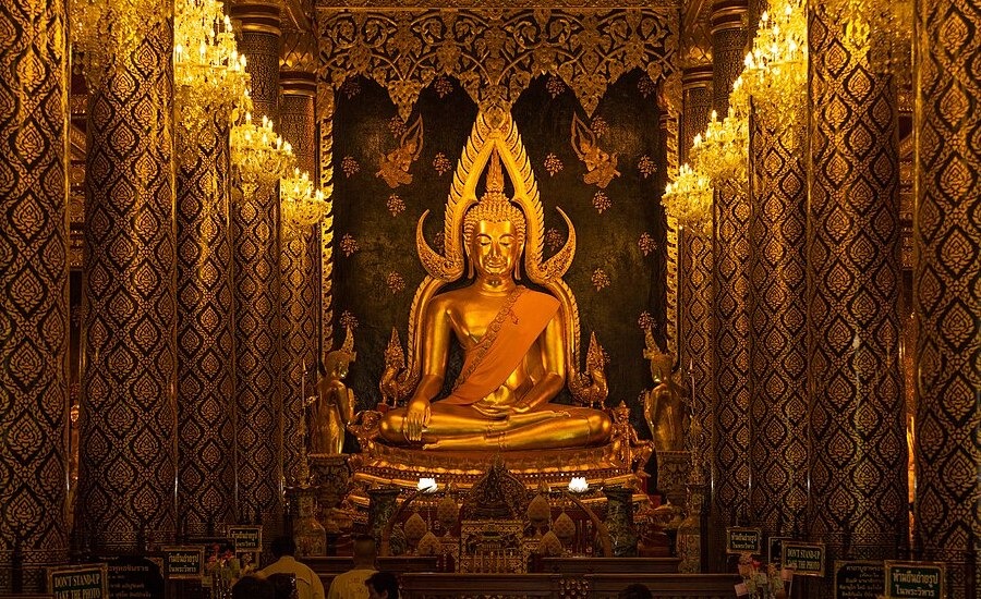 The Golden Buddha sits poignantly on a pedestal