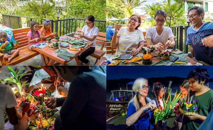 Tourist making traditional Loy Krathongs together for the Thai festival of light.